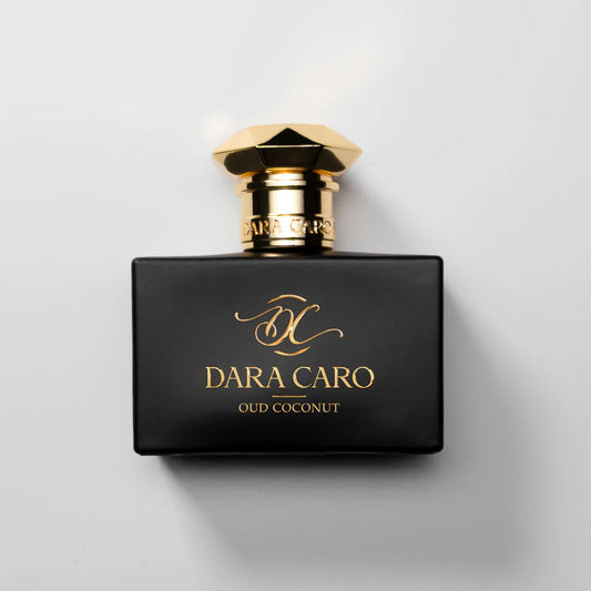 Black and gold Dara Caro perfume bottle on a light gray background