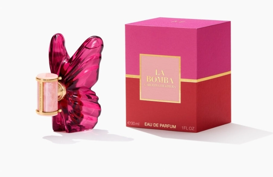 Pink butterfly-shaped perfume bottle with matching box on a white background